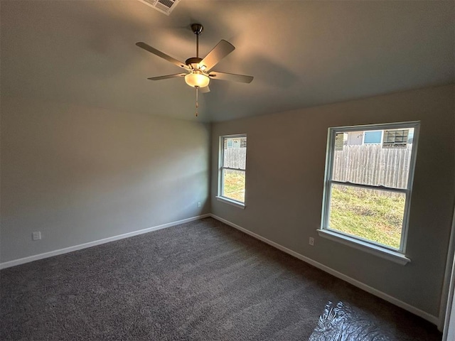 carpeted spare room with ceiling fan