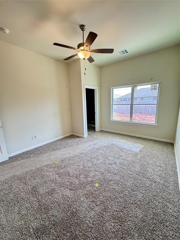 unfurnished bedroom with carpet floors, baseboards, visible vents, and ceiling fan