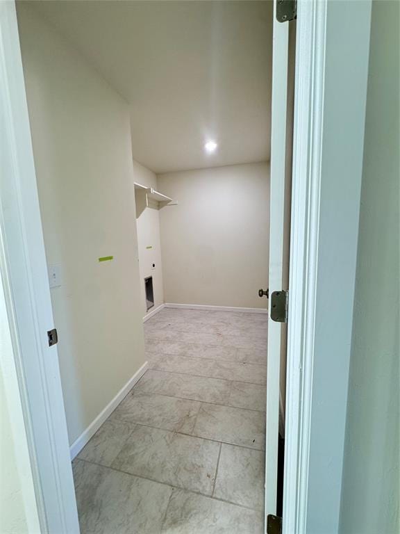 clothes washing area featuring laundry area and baseboards