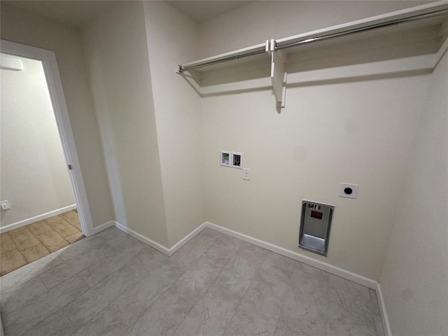 clothes washing area with laundry area, hookup for a washing machine, electric dryer hookup, and baseboards