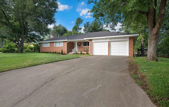 single story home featuring a garage and a front lawn