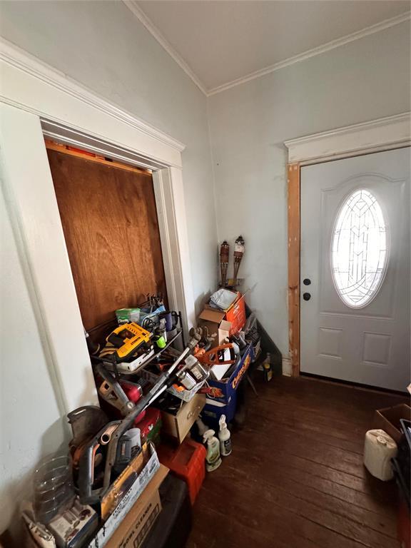 entrance foyer with crown molding and hardwood / wood-style flooring