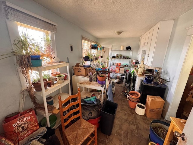 miscellaneous room with a textured ceiling