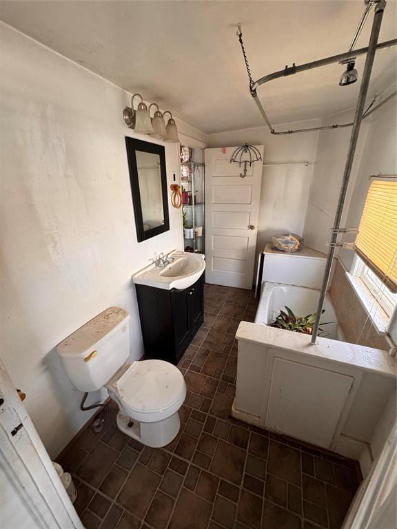 full bath featuring vanity, toilet, and a tub