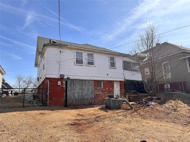 back of house featuring fence and central air condition unit