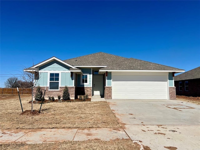 view of front facade with a garage, brick siding, fence, driveway, and roof with shingles