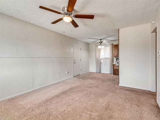 carpeted empty room with a textured ceiling