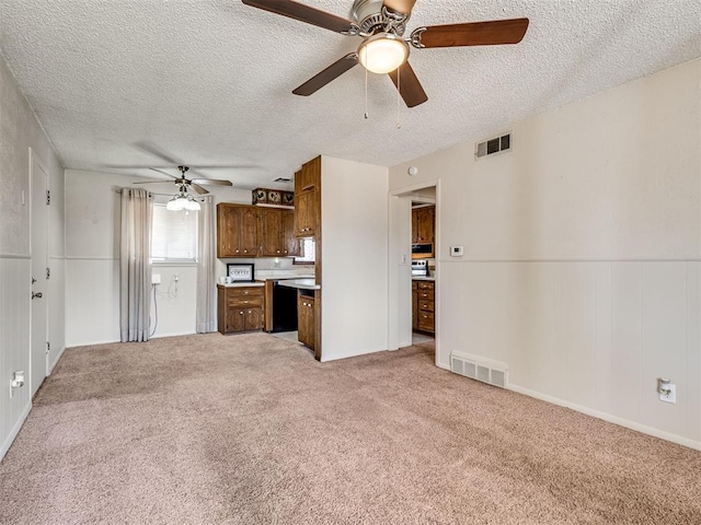 unfurnished living room with light carpet, visible vents, and a textured ceiling