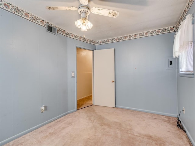 unfurnished room featuring baseboards, a ceiling fan, visible vents, and light colored carpet