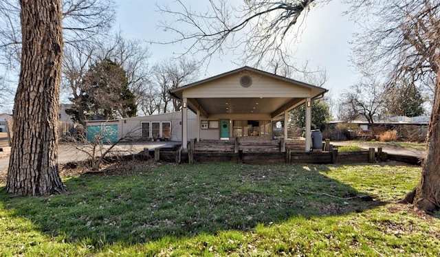 back of property featuring a patio area and a lawn