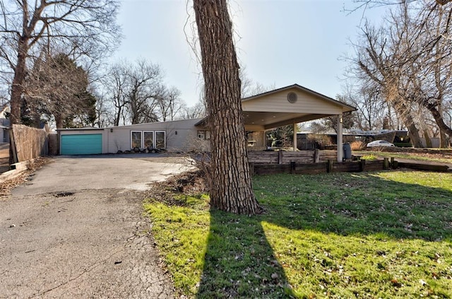 view of front of house with aphalt driveway and a front yard