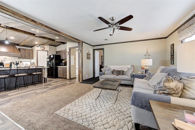 living room with a ceiling fan, light wood-style flooring, ornamental molding, vaulted ceiling with beams, and recessed lighting