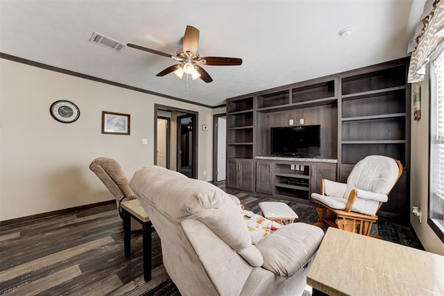 living room featuring crown molding, visible vents, dark wood-type flooring, a ceiling fan, and baseboards