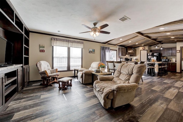 living room featuring a healthy amount of sunlight, visible vents, and dark wood finished floors