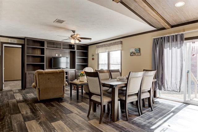 dining space featuring dark wood-style floors, visible vents, a ceiling fan, and beamed ceiling