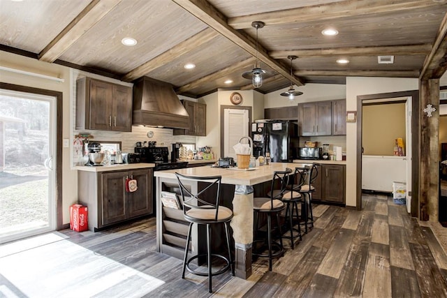 kitchen with light countertops, custom range hood, lofted ceiling with beams, plenty of natural light, and black appliances