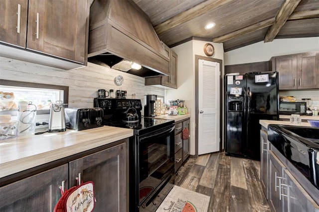 kitchen featuring custom exhaust hood, lofted ceiling with beams, dark wood-type flooring, dark brown cabinets, and black appliances