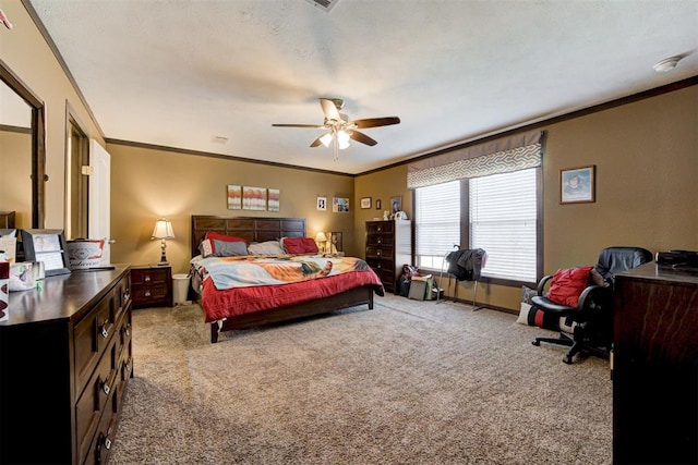 bedroom with ceiling fan, carpet floors, baseboards, and crown molding