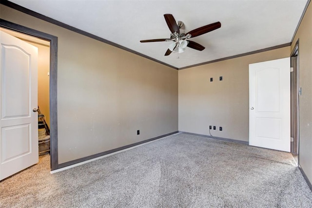 interior space featuring carpet, crown molding, baseboards, and ceiling fan