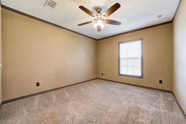 unfurnished room with visible vents, ornamental molding, carpet flooring, ceiling fan, and baseboards