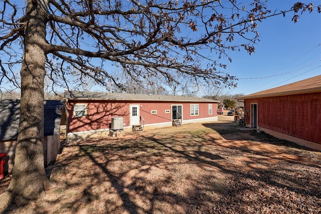 rear view of house with entry steps and cooling unit