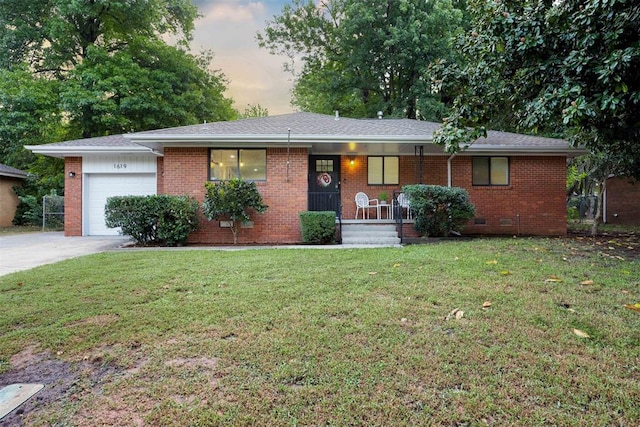 single story home featuring a yard and a garage