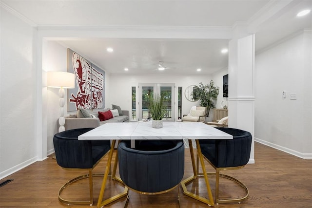 dining space featuring hardwood / wood-style flooring and crown molding