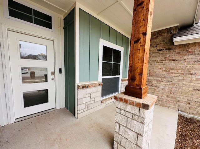 doorway to property with a porch and board and batten siding