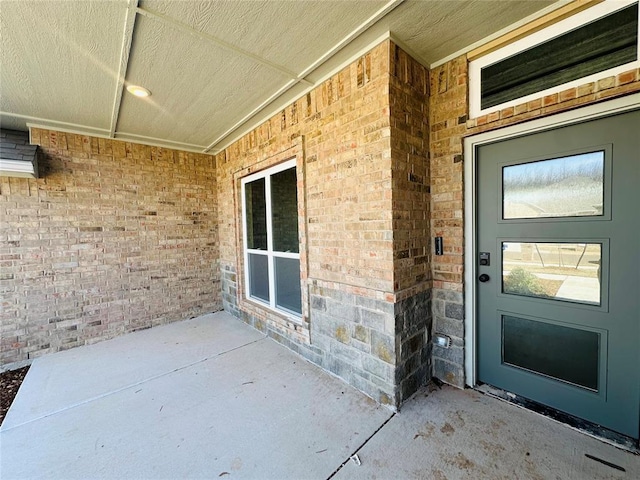 property entrance with brick siding