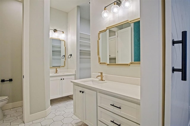 bathroom featuring vanity, tile patterned floors, and toilet