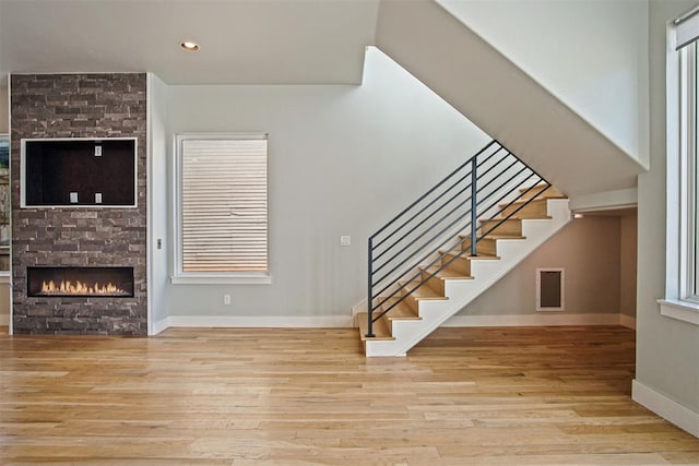 interior space featuring a fireplace, light hardwood / wood-style floors, and plenty of natural light