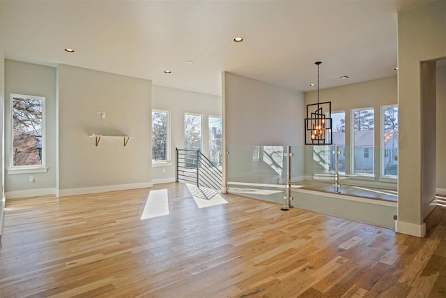 interior space featuring an inviting chandelier and light wood-type flooring