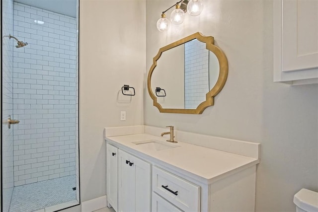 bathroom with vanity and tiled shower