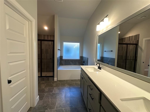 bathroom with plus walk in shower, vanity, and vaulted ceiling