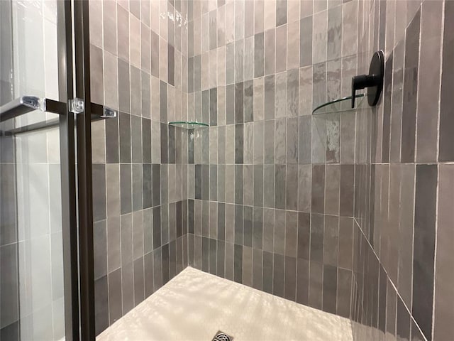 bathroom with tiled shower