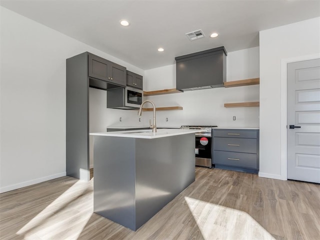 kitchen with open shelves, light countertops, visible vents, appliances with stainless steel finishes, and a sink
