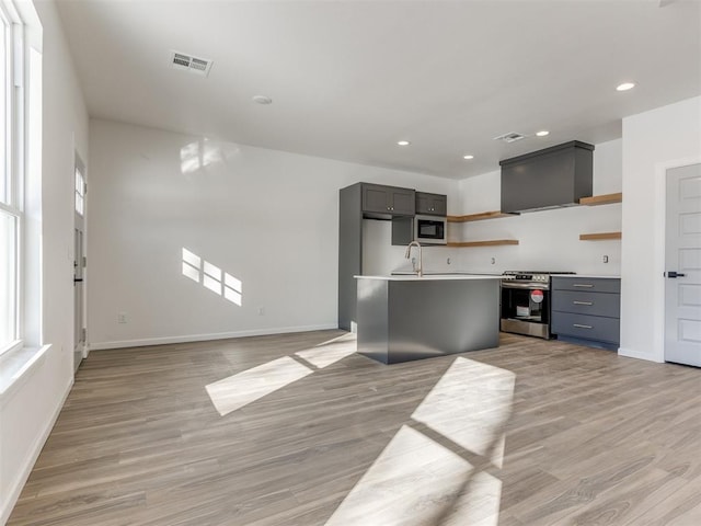 kitchen featuring open shelves, electric range, light wood-style flooring, and visible vents