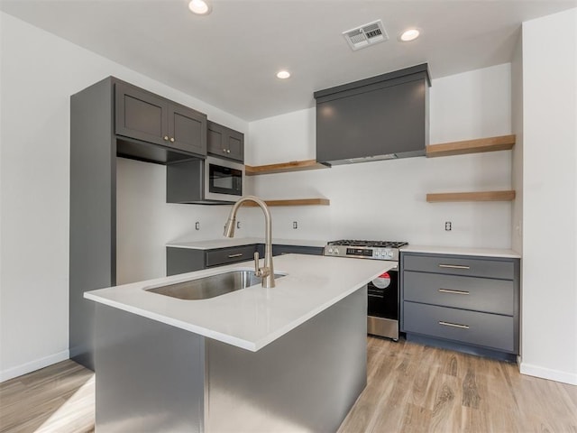 kitchen featuring open shelves, appliances with stainless steel finishes, ventilation hood, and a sink