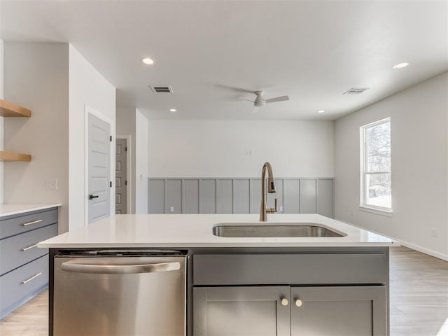 kitchen with a sink, visible vents, dishwasher, and gray cabinetry