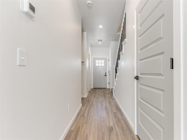 corridor featuring recessed lighting, light wood-style flooring, and baseboards