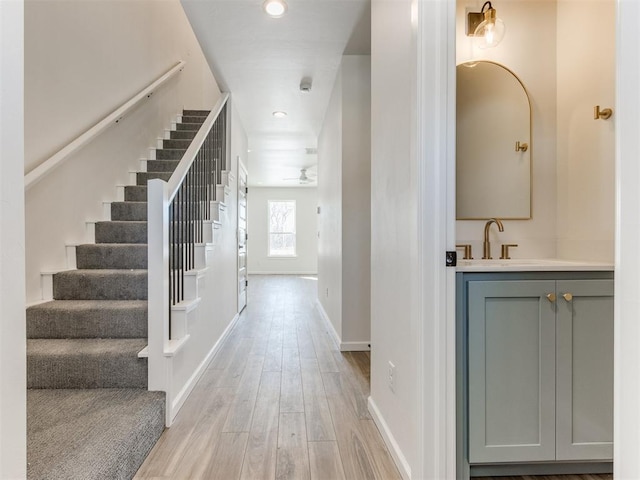 foyer featuring stairs, recessed lighting, light wood-style flooring, and baseboards