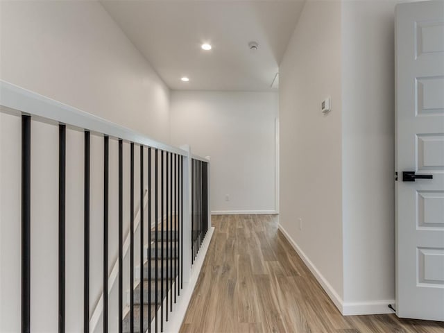 hall with recessed lighting, wood finished floors, and baseboards