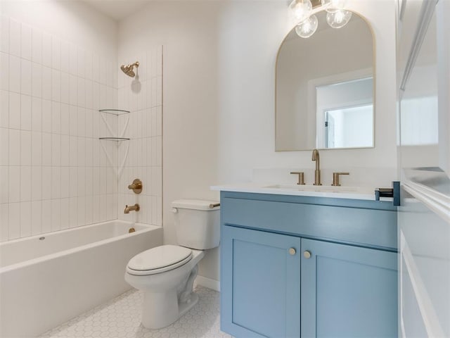 bathroom featuring shower / bathing tub combination, toilet, vanity, tile patterned flooring, and baseboards