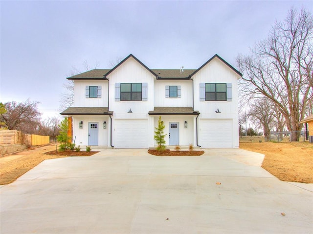 modern inspired farmhouse featuring roof with shingles, fence, driveway, and an attached garage