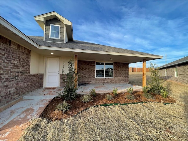 view of exterior entry featuring a patio