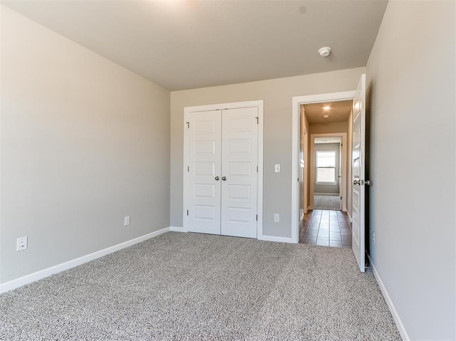 unfurnished bedroom with carpet floors and a closet