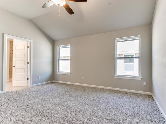 carpeted empty room featuring ceiling fan and vaulted ceiling