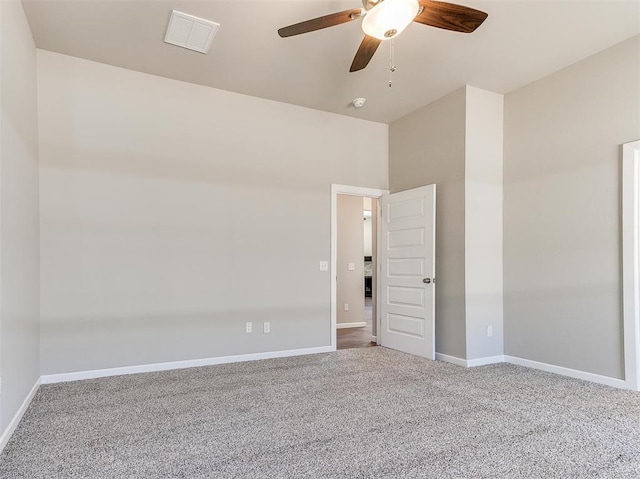 empty room featuring ceiling fan and carpet flooring