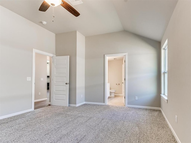 unfurnished bedroom with carpet, vaulted ceiling, ensuite bath, and ceiling fan