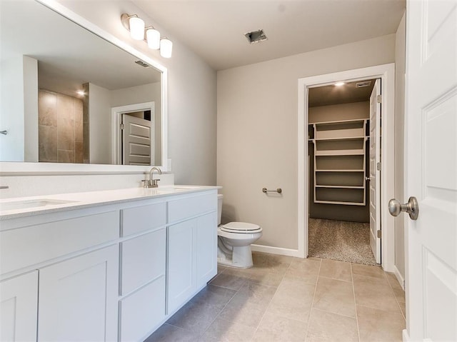 bathroom with tile patterned floors, toilet, and vanity